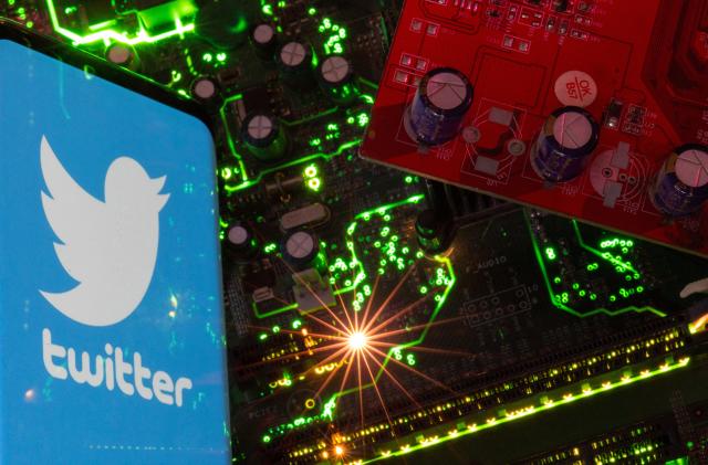 A smartphone with a displayed Twitter logo is placed on a computer motherboard in this illustration taken February 23, 2023. REUTERS/Dado Ruvic/Illustration