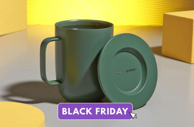 Product marketing photo of the Ember Smart Mug 2 in green. It sits on a whimsical table with a gray surface with several yellow blocks and geometrical shapes sitting aside it.
