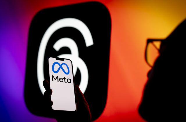 The Meta logo is seen on a phone with the Instagram Threads app logo in the background in this illustration photo on 06 July, 2023 in Warsaw, Poland. (Photo by Jaap Arriens/NurPhoto via Getty Images)