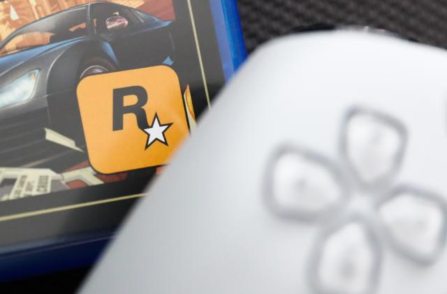 Rockstar Games logo on Grand Theft Auto V game packaging and PlayStation DualSense controller are seen in this illustration photo taken in Krakow, Poland on August 10, 2023. (Photo by Jakub Porzycki/NurPhoto via Getty Images)