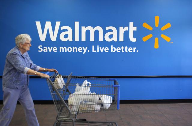 A customer leaves a Wal-Mart store in Rogers, Arkansas June 4, 2009. Wal-Mart Stores Inc said on Thursday that its strong financial position leaves it well positioned to take advantage of acquisition opportunities across the globe.      REUTERS/Jessica Rinaldi (UNITED STATES BUSINESS)