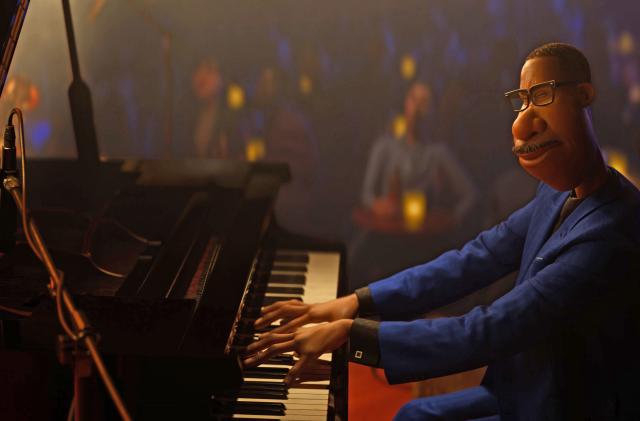 A man sits at a piano in a jazz club in Pixar's Soul.