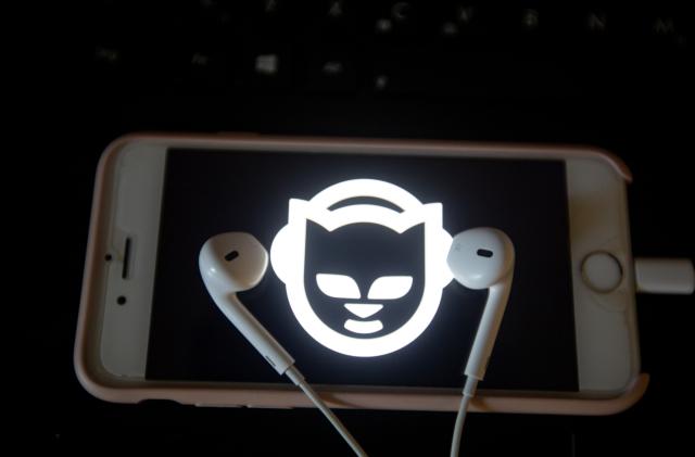 The app of the music streaming app Napster is seen on a screen while some headphones are lying on it. The numbers of people using music streaming apps grow. The biggest one is the Swedish Spotify with 83 million paying users and about 100 others, that use the free version. (Photo by Alexander Pohl/NurPhoto via Getty Images)