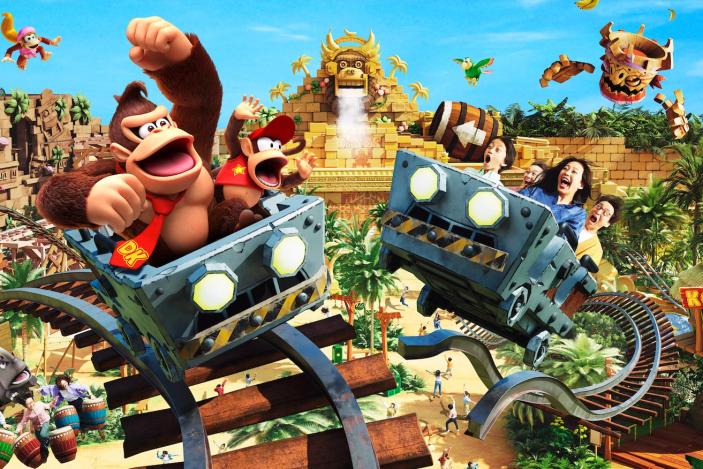 Donkey Kong Country area at Super Nintendo World Japan, showing Donkey and Diddy Kong riding in one mine cart and humans on another.