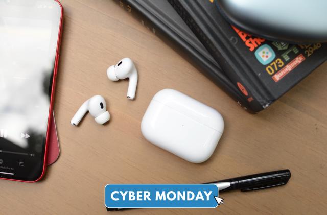 The Apple AirPods Pro laid on a desk with Cyber Monday logo.
