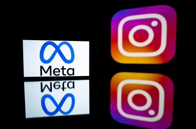 This picture taken on January 12, 2023 in Toulouse, southwestern France shows a smartphone and a computer screen displaying the logos of Instagram app and its parent company Meta. (Photo by Lionel BONAVENTURE / AFP) (Photo by LIONEL BONAVENTURE/AFP via Getty Images)