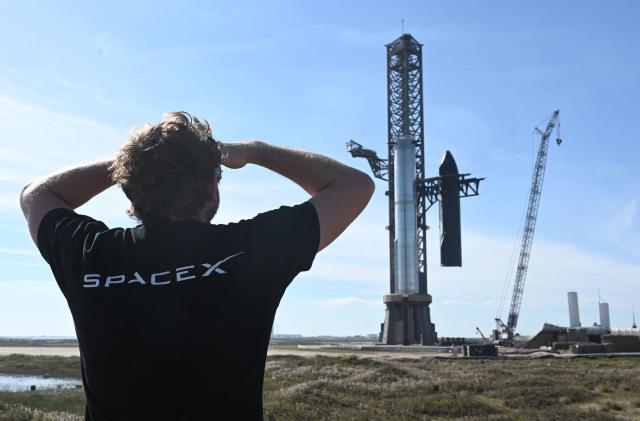 TOPSHOT - A person looks on as SpaceX's huge Super Heavy-Starship is unstacked from the booster as it sits on the launchpad at Starbase in Boca Chica, Texas, on November 16, 2023, ahead of its second test flight posponed to November 18. The US Federal Aviation Administration (FAA) on November 15, 2023 authorized SpaceX to carry out its second launch of Starship, the most powerful rocket ever built, after a first attempt in April ended in a spectacular explosion. (Photo by TIMOTHY A. CLARY / AFP) (Photo by TIMOTHY A. CLARY/AFP via Getty Images)