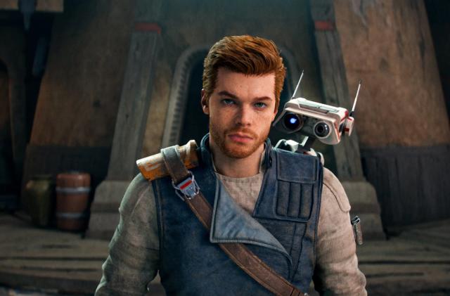 Cal Kestis, the protagonist of Star Wars Jedi: Survivor, with BD-1, his droid companion, against the backdrop of a tan building.  