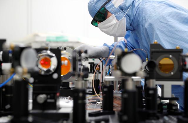 A technican of Trumpf, a hidden Champion of the German Mittelstand that supplies CO2 laser technology to Dutch ASML and the leader of semiconductor lithography machines, adjusts optical parts for one of their CO2 lasers at the Trumpf headquarters in Ditzingen, Germany, May 15, 2019. Picture taken May 15, 2019. REUTERS/Kai Pfaffenbach