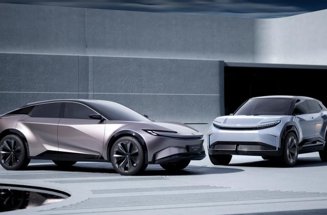 Two electric SUV concepts from Toyota sit in a modern showroom. A crossover with fastback (sloping) profile sits on the left, and an “Urban SUV” is on the right.